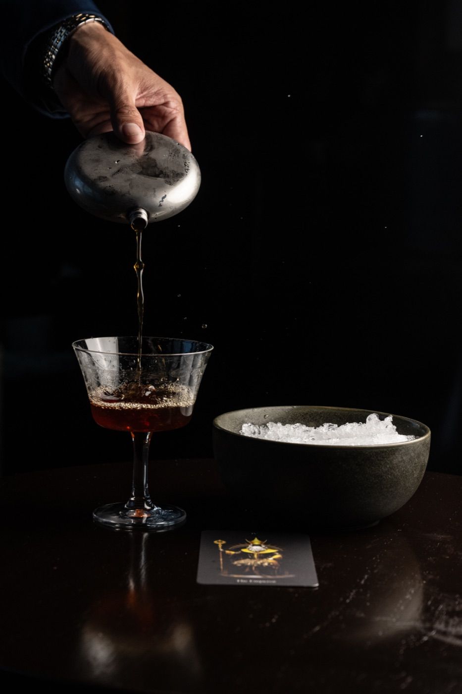 Cocktail being poured from a flask at Arcano