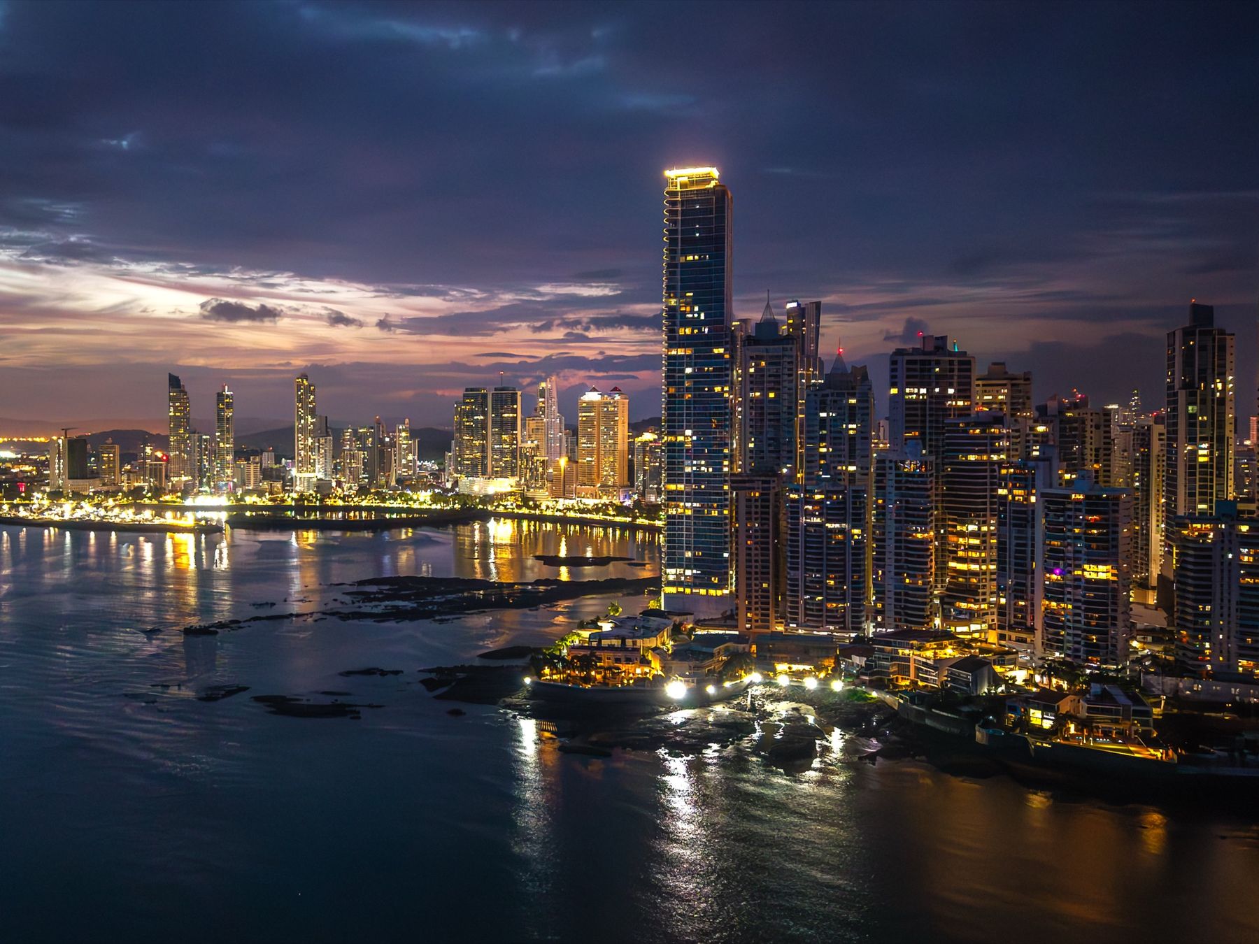 Panama City skyline at night, where the speakeasy tour begins